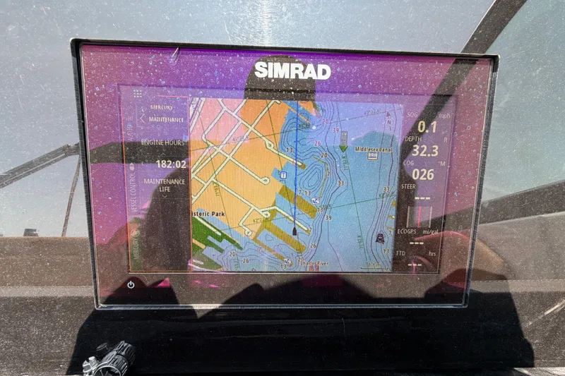 Slide: The Image of Simrad navigation display on 2019 Sea Ray SDX 250 Outboard, showing map and engine data. - 13