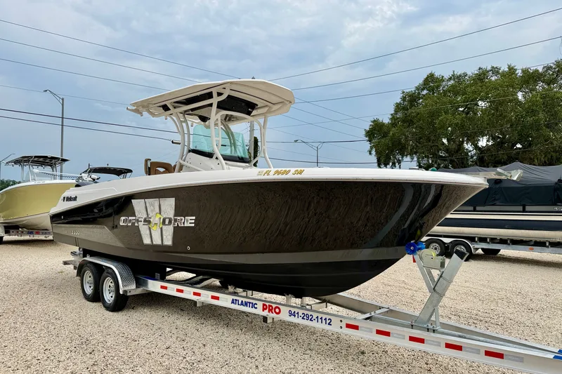 Slide: The Image of 2019 Wellcraft 262 Fisherman boat on trailer, displayed outdoors. - 3