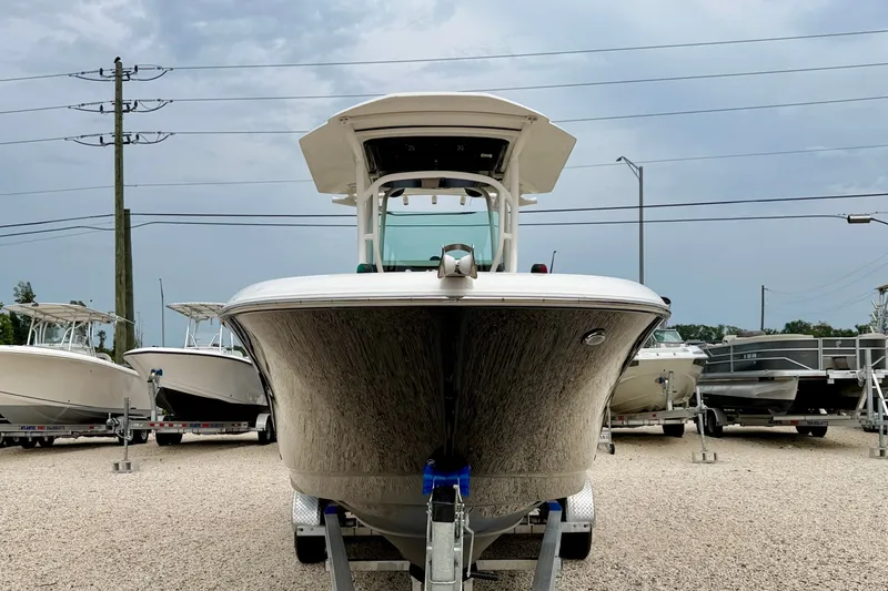 Slide: The Image of 2019 Wellcraft 262 Fisherman boat on trailer, displayed outdoors under cloudy sky. - 2