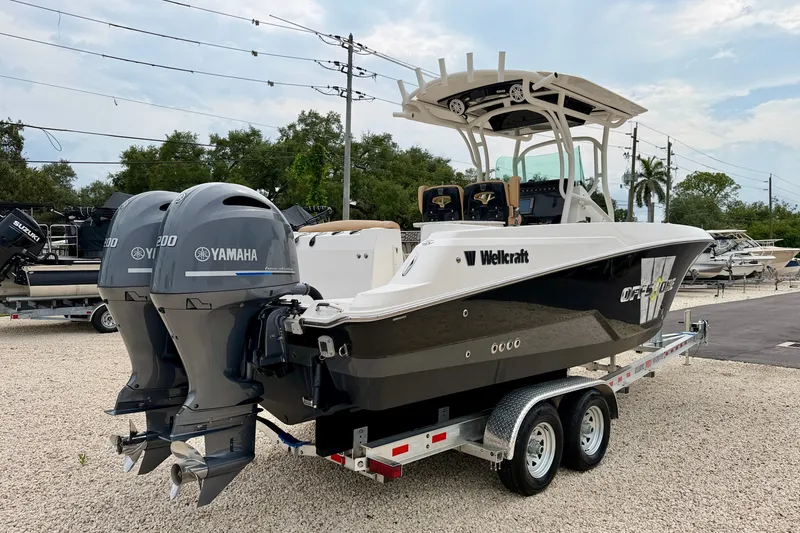 Slide: The Image of 2019 Wellcraft 262 Fisherman boat with dual Yamaha engines on a trailer. - 7