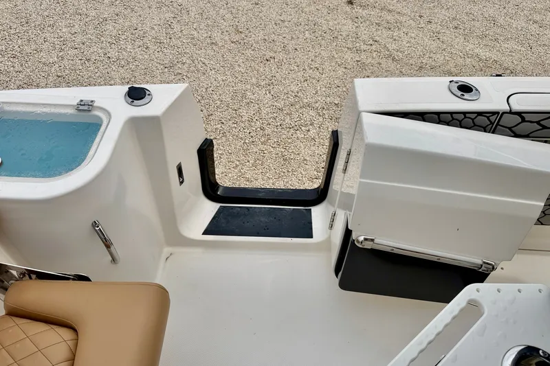 Slide: The Image of 2019 Wellcraft 262 Fisherman boat interior with seating and storage compartments. - 27