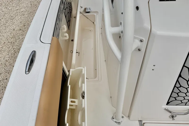 Slide: The Image of 2019 Wellcraft 262 Fisherman boat interior with storage compartments and seating. - 32