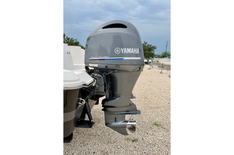 Slide: The Image of Yamaha outboard motor on 2019 Wellcraft 262 Fisherman boat, parked on gravel. - 35