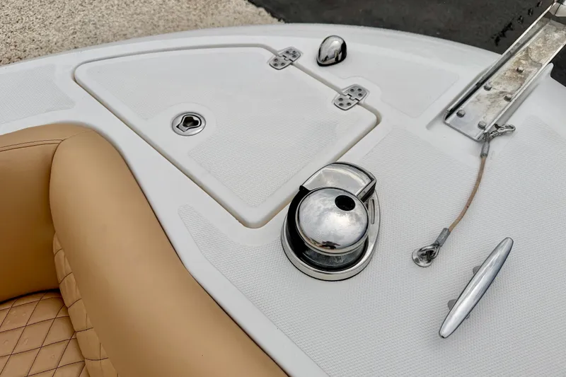 Slide: The Image of 2019 Wellcraft 262 Fisherman boat deck with tan seating and chrome fittings. - 29