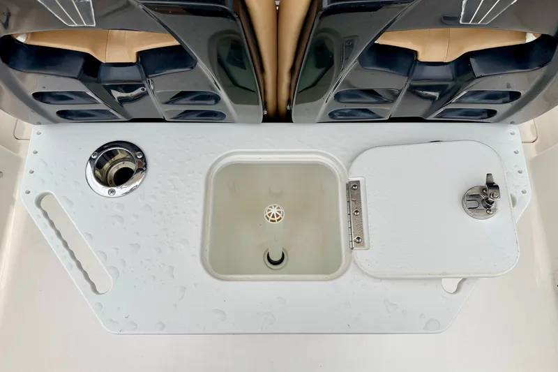 Slide: The Image of 2019 Wellcraft 262 Fisherman boat's bait station with storage and rod holders. - 28
