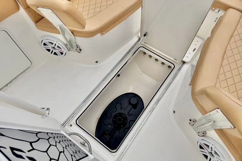 Slide: The Image of 2019 Wellcraft 262 Fisherman boat interior with storage compartment and tan seating. - 31