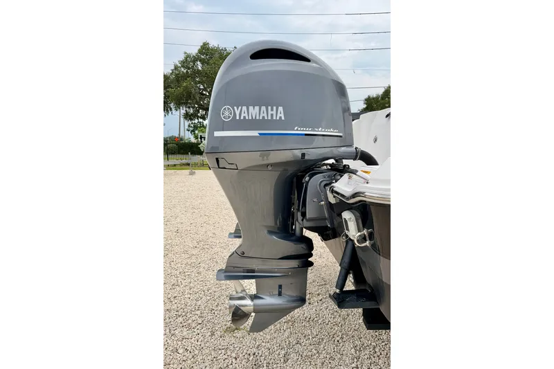 Slide: The Image of Yamaha outboard motor on a 2019 Wellcraft 262 Fisherman boat, parked on gravel. - 36