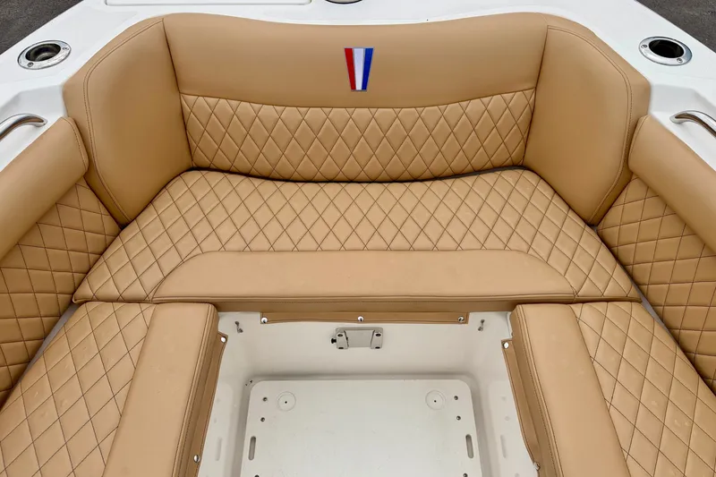 Slide: The Image of Luxurious tan seating on 2019 Wellcraft 262 Fisherman boat, featuring diamond stitching and cup holders. - 12