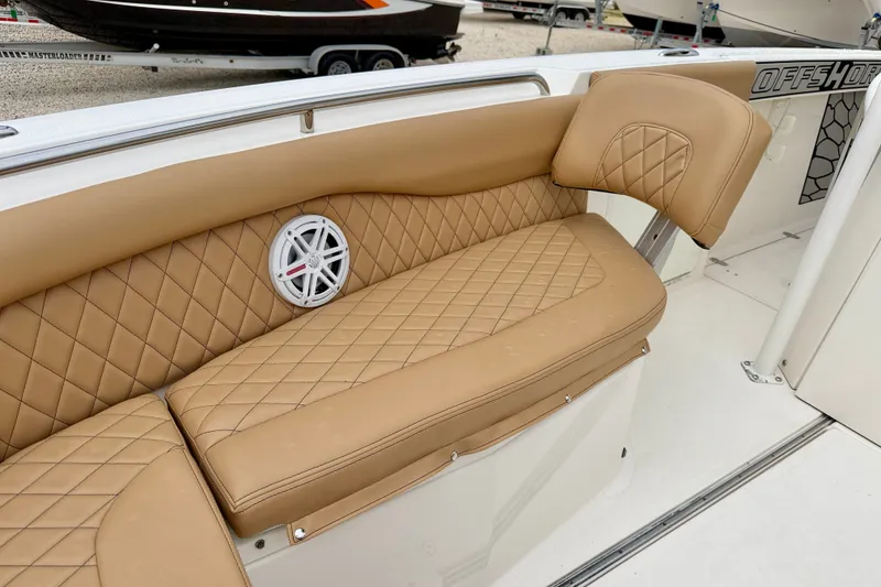 Slide: The Image of Luxurious tan seating on 2019 Wellcraft 262 Fisherman boat with diamond stitching and speaker. - 11