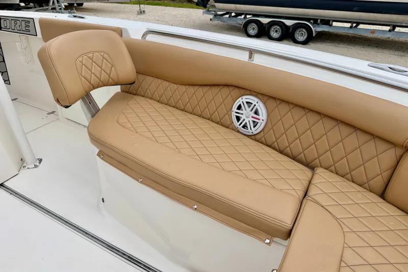 Slide: The Image of Luxurious tan seating on 2019 Wellcraft 262 Fisherman boat with diamond stitching and speaker. - 10
