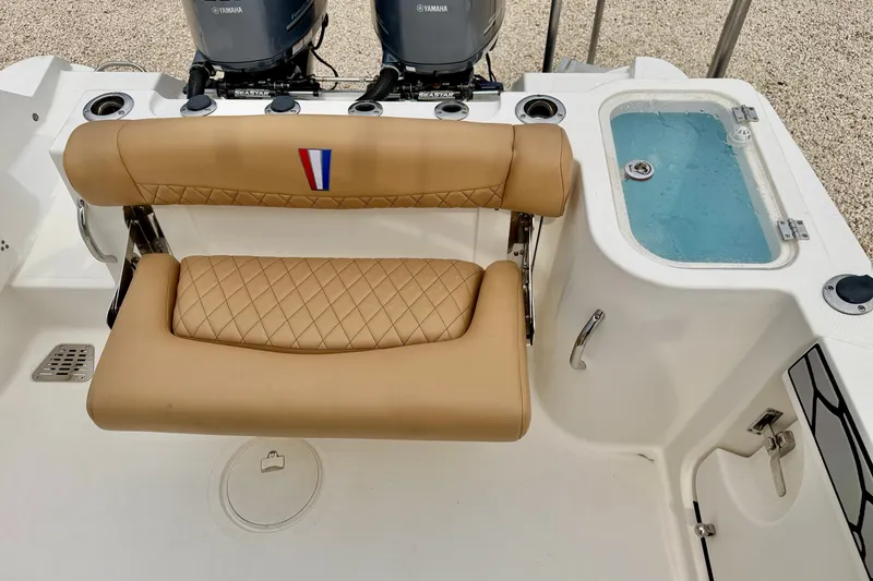 Slide: The Image of 2019 Wellcraft 262 Fisherman boat interior with tan seating and livewell. - 23