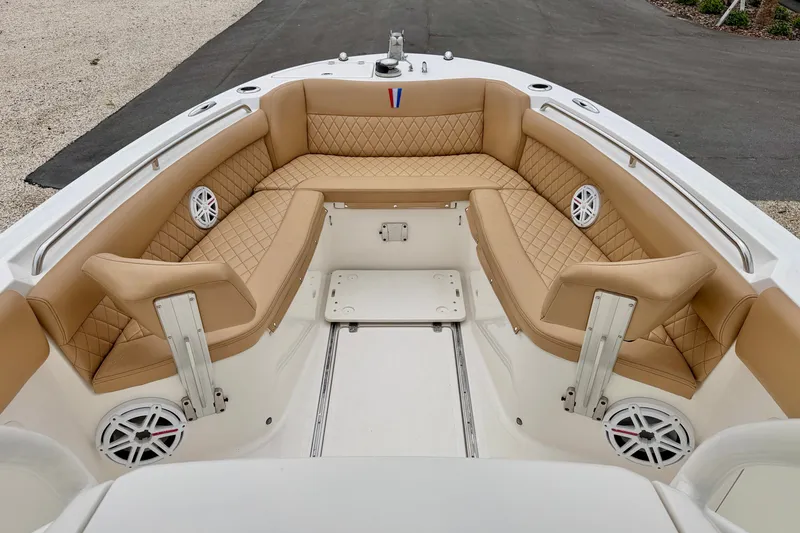 Slide: The Image of 2019 Wellcraft 262 Fisherman boat with tan quilted seating and built-in speakers. - 9