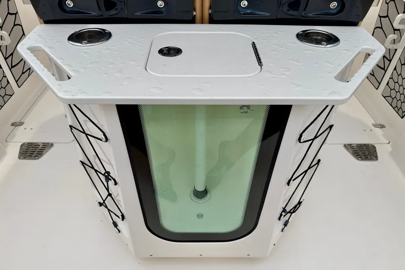 Slide: The Image of 2019 Wellcraft 262 Fisherman boat livewell with rod holders and cup holders. - 26