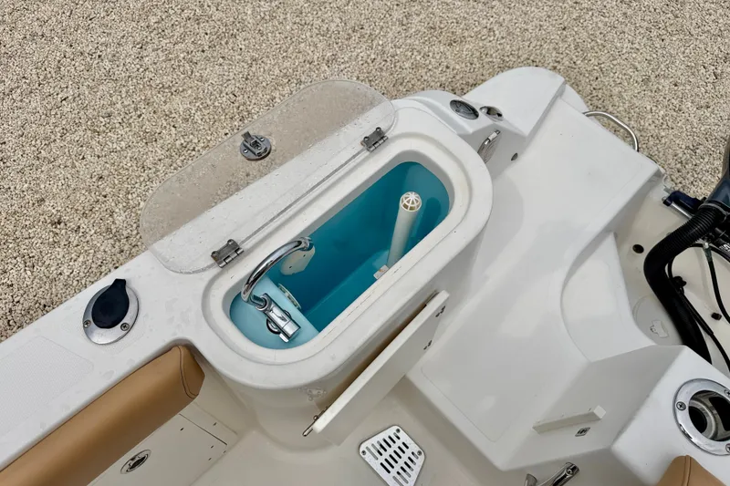 Slide: The Image of 2019 Wellcraft 262 Fisherman boat livewell with open lid, showcasing interior features. - 25