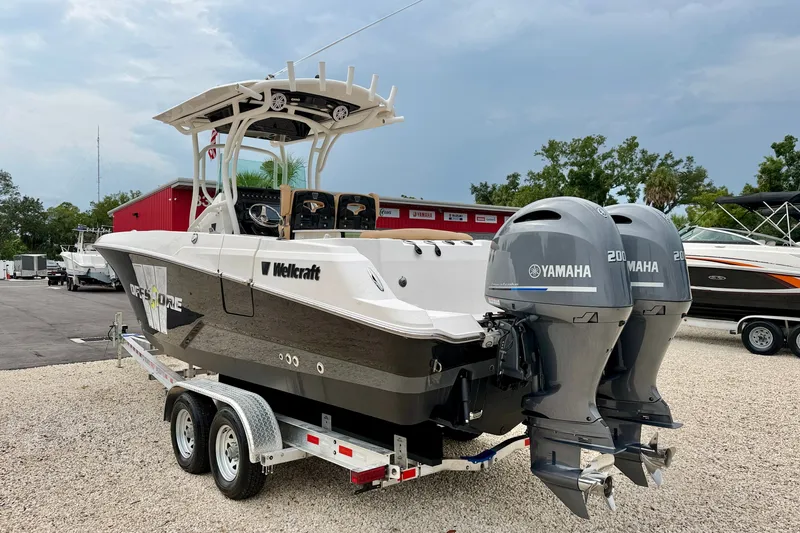 Slide: The Image of 2019 Wellcraft 262 Fisherman boat with twin Yamaha engines on a trailer. - 5