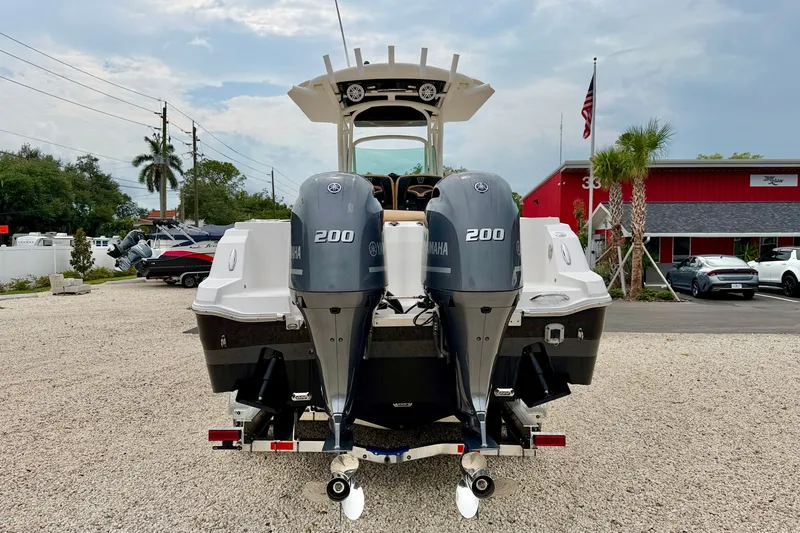 Slide: The Image of 2019 Wellcraft 262 Fisherman boat with dual Yamaha 200 engines, parked outdoors. - 6