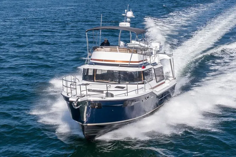The Image of Manufacturer Provided Image: 2025 Ranger Tugs R-43 CB cruising on open water, showcasing sleek design and performance. - 0