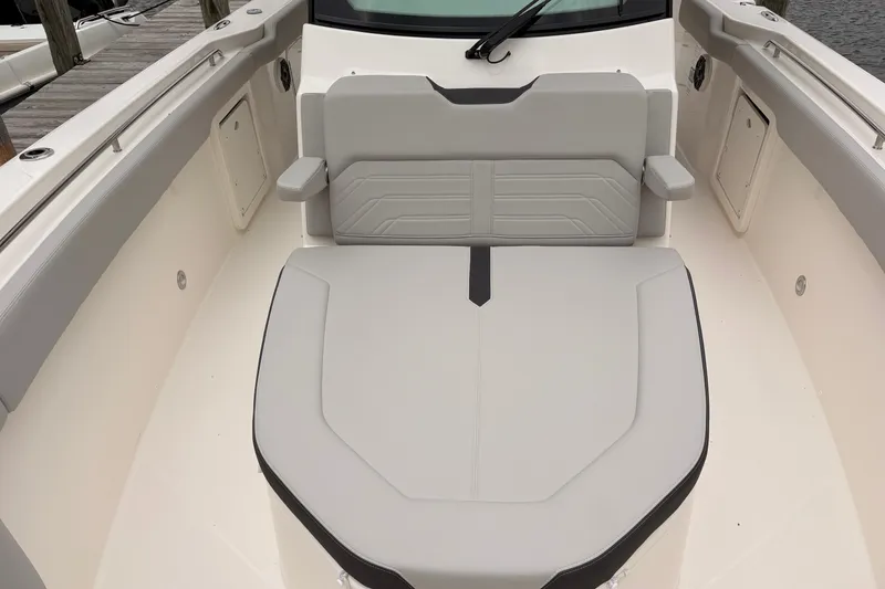 Slide: The Image of 2026 Boston Whaler 330 Outrage boat seating area, featuring sleek, modern design and comfortable upholstery. - 16
