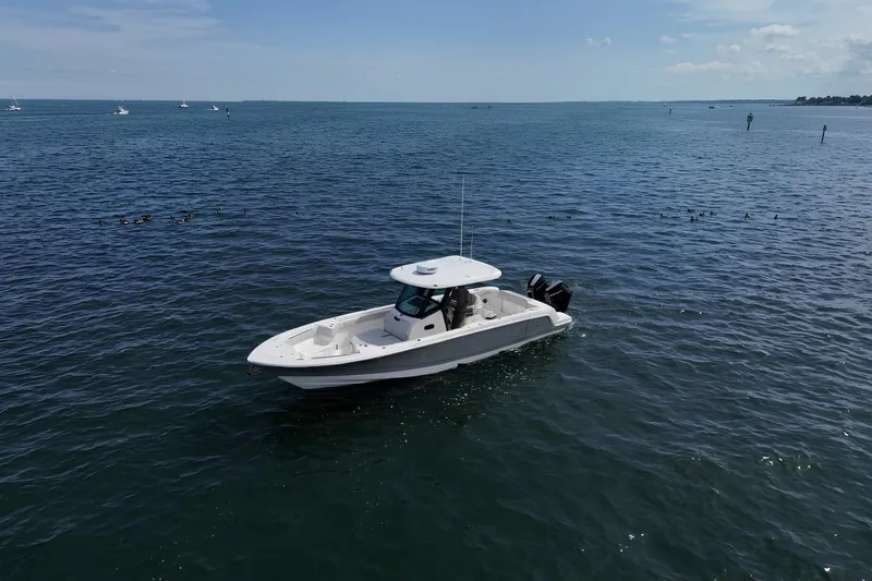 The Image of 2026 Boston Whaler 330 Outrage boat cruising on open water under clear skies. - 0