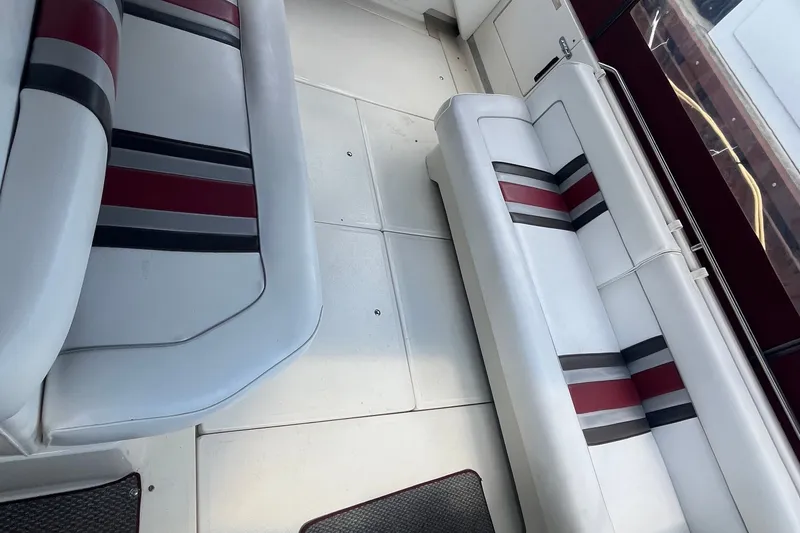 Slide: The Image of The image shows the cockpit of a 1990 Sea Ray Sundancer 350 with white seats and red accents. - 7