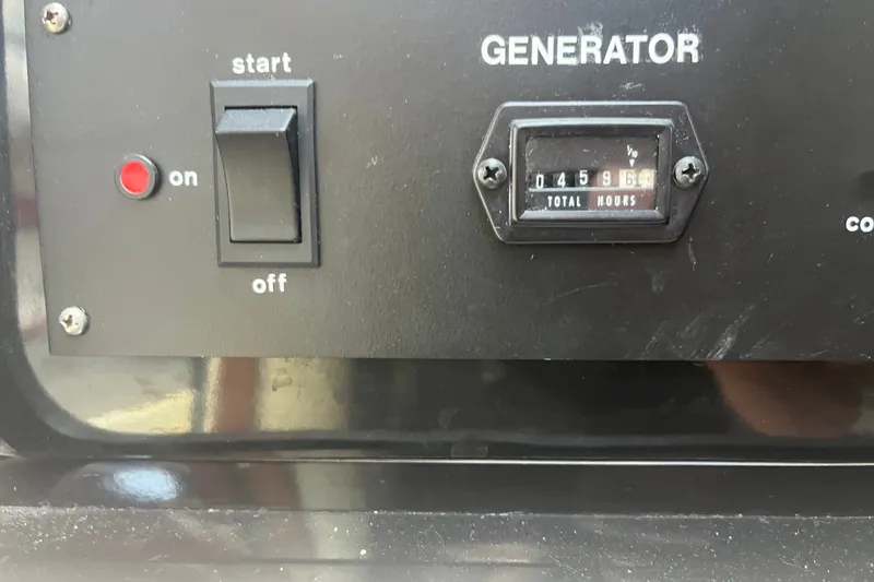 Slide: The Image of Generator control panel with hour meter reading 4596 hours on a 1990 Sea Ray Sundancer 350. - 10