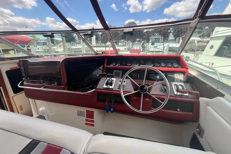 Slide: The Image of Cockpit of 1990 Sea Ray Sundancer 350 with steering wheel and control panel. - 3