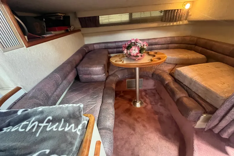 Slide: The Image of Interior of 1990 Sea Ray Sundancer 350 with cozy seating and floral centerpiece. - 12