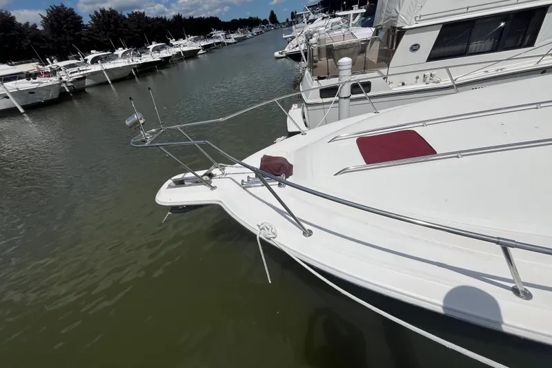 Slide: The Image of 1990 Sea Ray Sundancer 350 docked in a marina, surrounded by other boats. - 19