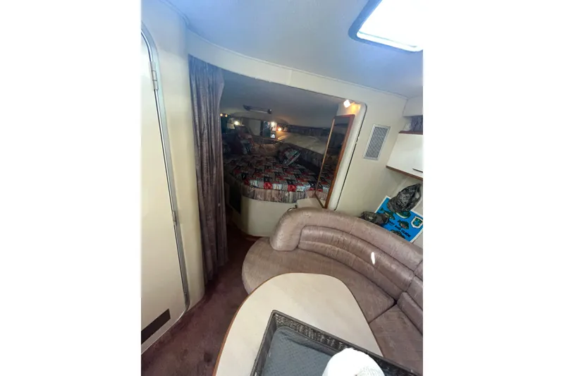 Slide: The Image of Interior of 1990 Sea Ray Sundancer 350 with cozy seating and sleeping area. - 16