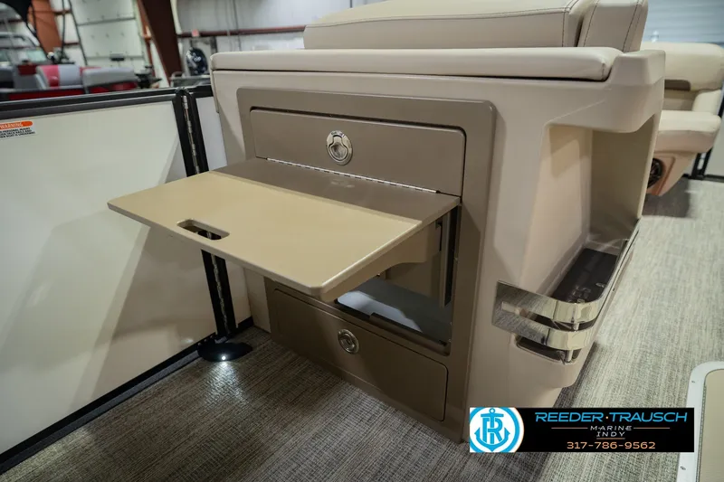 Slide: The Image of 2026 Bennington 24 MSB boat interior with fold-out table and storage compartments. - 33