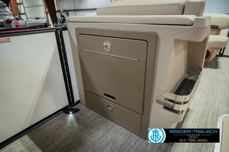 Slide: The Image of 2026 Bennington 24 MSB boat interior storage compartment with beige upholstery and sleek design. - 30