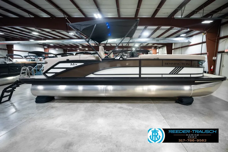 Slide: The Image of 2026 Bennington 24 MSB pontoon boat in showroom, side view with canopy. - 6