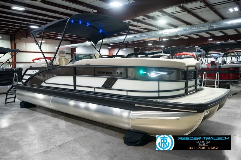 Slide: The Image of 2026 Bennington 24 MSB pontoon boat displayed indoors with canopy and modern design. - 5