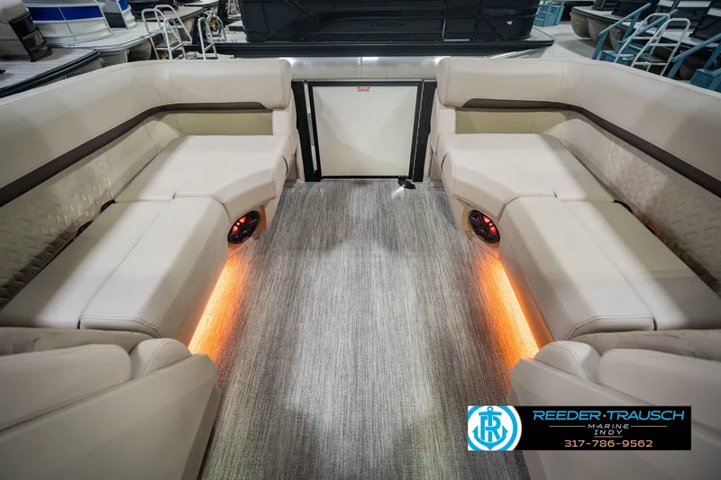 Slide: The Image of Luxurious interior of 2026 Bennington 24 MSB pontoon boat with ambient lighting. - 21