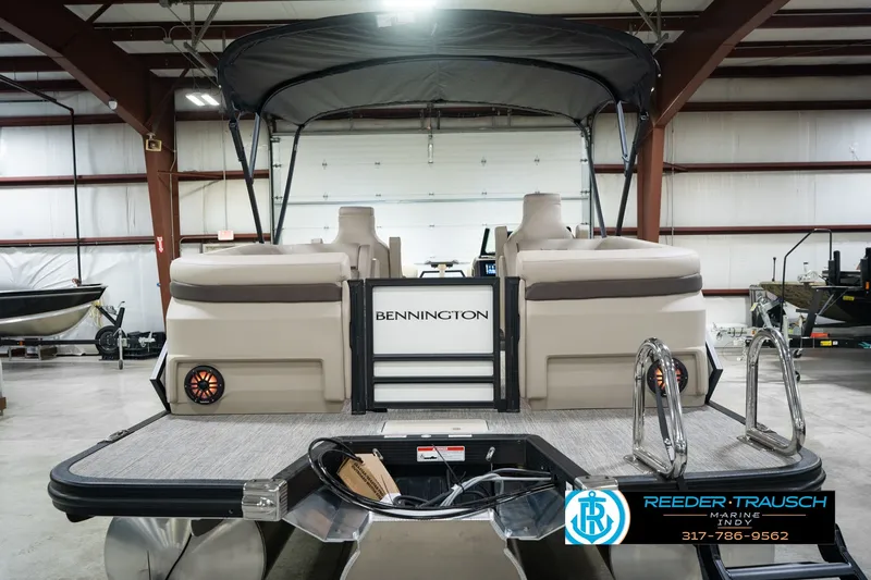 Slide: The Image of 2026 Bennington 24 MSB pontoon boat in showroom, featuring spacious seating and modern design. - 9