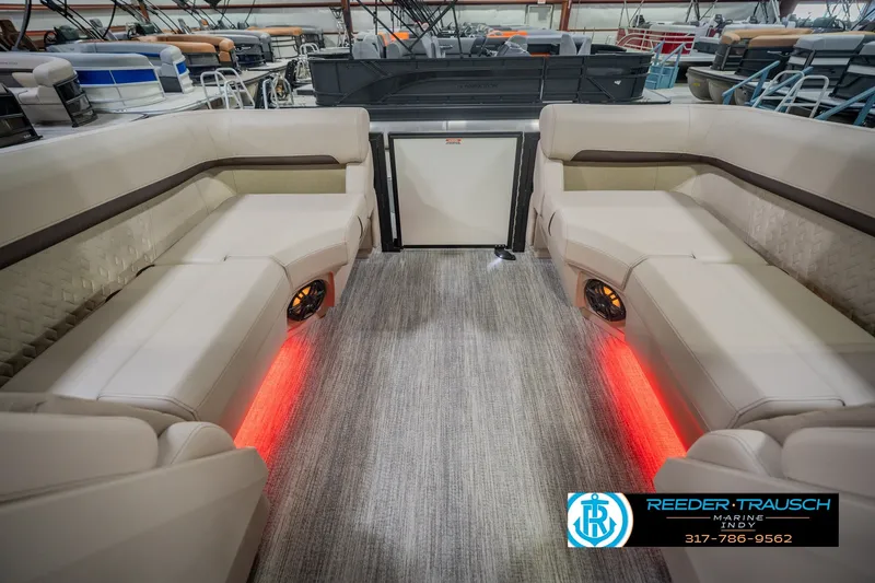 Slide: The Image of Luxurious interior of 2026 Bennington 24 MSB pontoon boat with ambient lighting. - 36