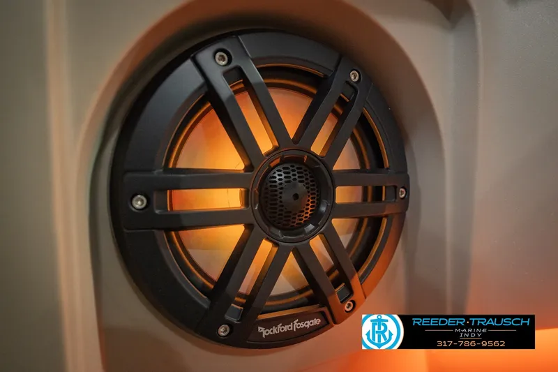 Slide: The Image of Rockford Fosgate speaker on 2026 Bennington 24 MSB boat, illuminated with warm lighting. - 51