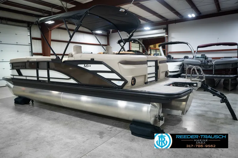 Slide: The Image of 2026 Bennington 24 MSB pontoon boat displayed indoors at Reeder Trausch Marine. - 10