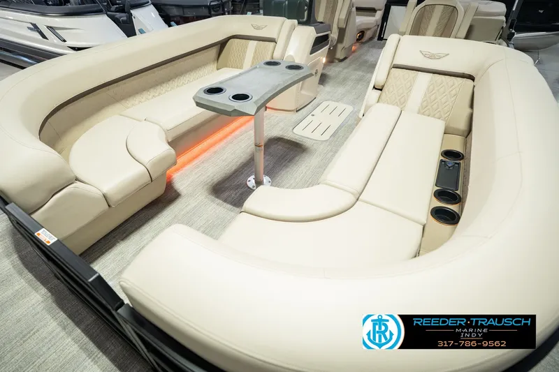 Slide: The Image of Luxurious interior of 2026 Bennington 24 MSB pontoon boat with plush seating and cup holders. - 13