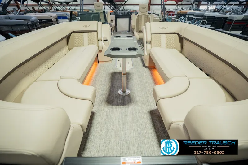 Slide: The Image of Luxurious interior of 2026 Bennington 24 MSB pontoon boat with beige seating and table. - 18