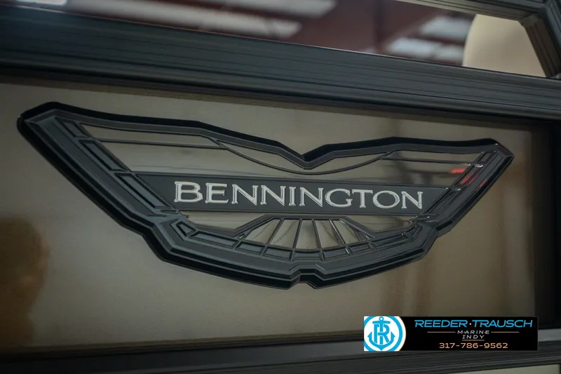 Slide: The Image of Bennington 24 MSB 2026 logo on a sleek boat surface, featuring Reeder Trausch Marine contact. - 54