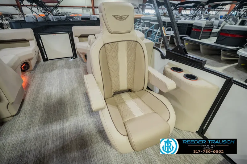 Slide: The Image of Luxurious seating on 2026 Bennington 24 MSB pontoon boat, featuring beige upholstery and cup holders. - 35