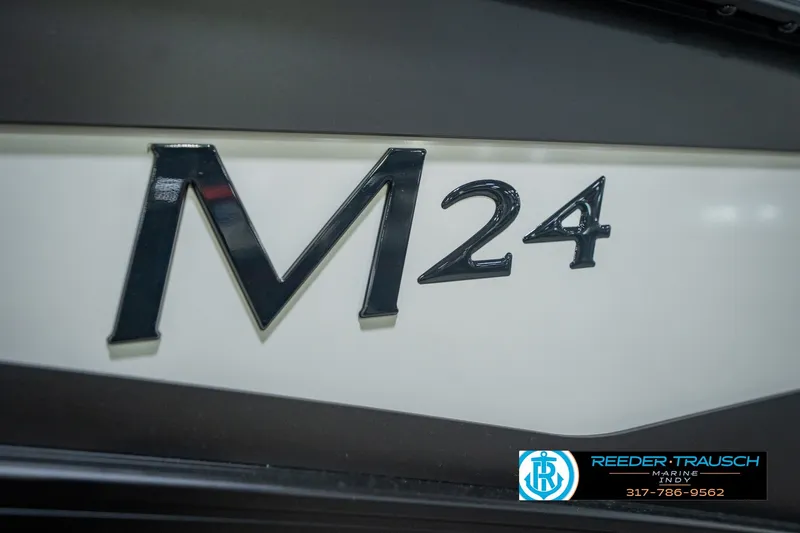 Slide: The Image of Close-up of 2026 Bennington 24 MSB model emblem with dealership logo. - 56
