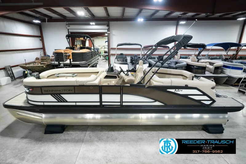The Image of 2026 Bennington 24 MSB pontoon boat displayed in a showroom. - 0