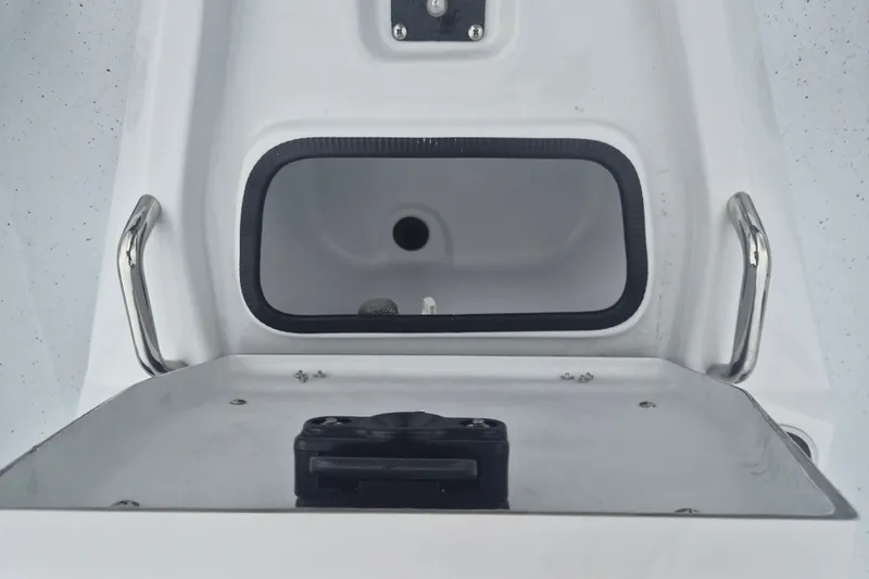 Slide: The Image of 2027 Xpress H20B Bay boat interior with storage compartment and stainless steel handles. - 16