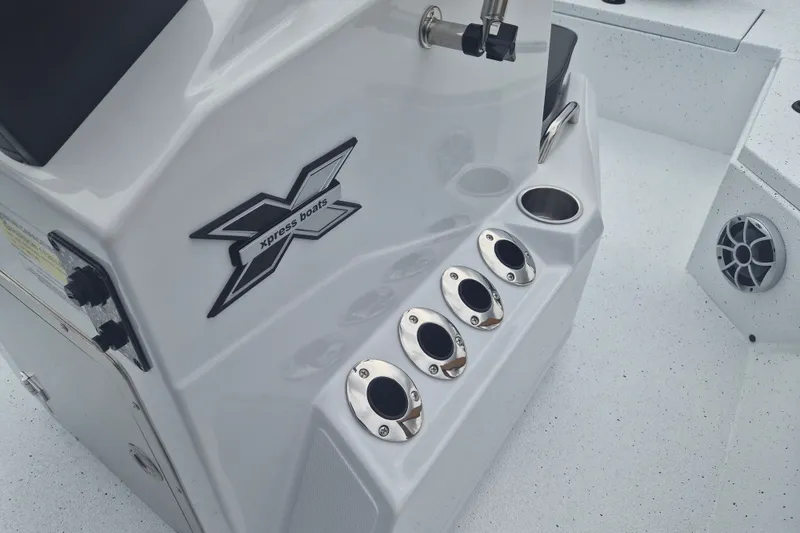 Slide: The Image of 2027 Xpress H20B Bay boat console with cup holders and speaker detail. - 13