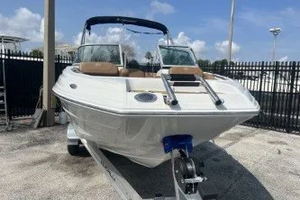 Slide: The Image of 2023 Crownline Eclipse E215 XS boat on trailer, parked outdoors. - 3