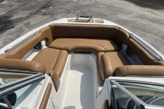 Slide: The Image of 2023 Crownline Eclipse E215 XS boat interior with brown seating and sleek design. - 10