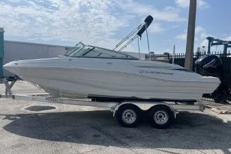Slide: The Image of 2023 Crownline Eclipse E215 XS boat on trailer, parked outdoors. - 5