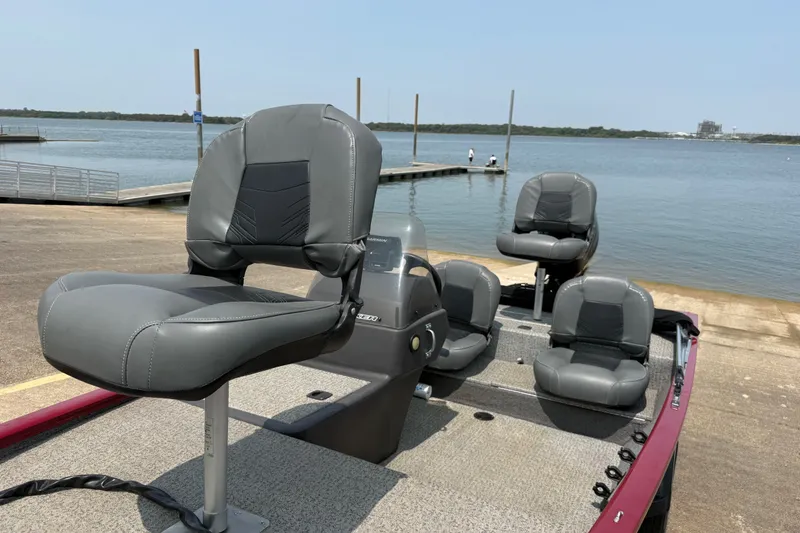 Slide: The Image of 2020 Tracker Pro 160 boat with gray seats at a lakeside dock. - 22